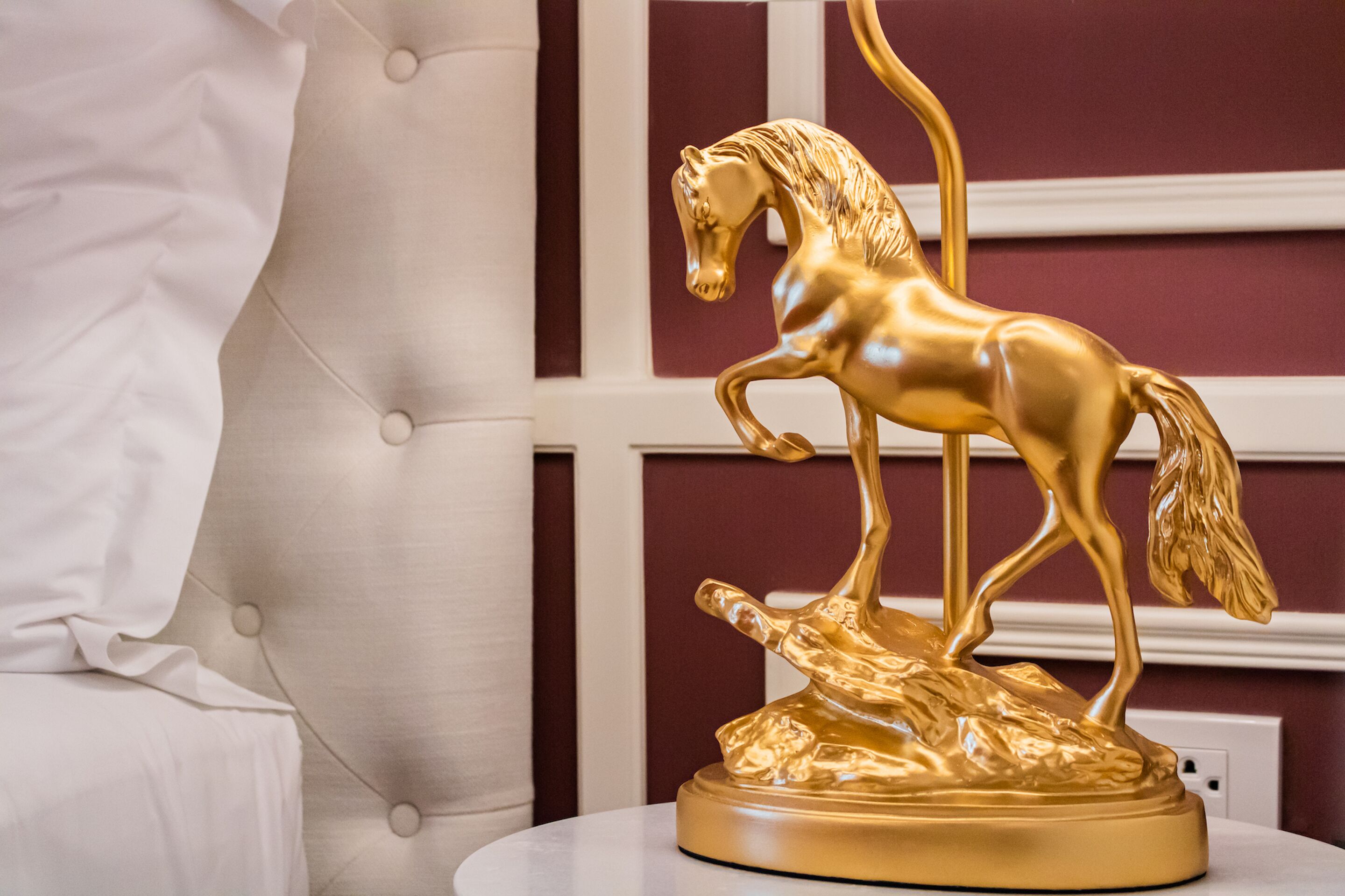A golden horse statue on a pedestal.