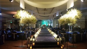A formal event setup with a long table, chairs, and floral arrangements. - Kumho Tongyeong Marina Resort (Tongyeong)