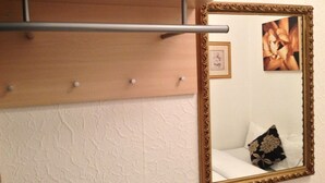 A mirror with an ornate gold frame, a wooden shelf above it, and a small framed picture on the wall. - Wilsons Hotel - Blackpool Tower View (Blackpool)