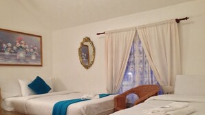 A hotel room with two beds, a painting on the wall, and a window with curtains. - Wilsons Hotel - Blackpool Tower View (Blackpool)
