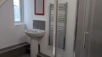 Shower, hair dryer, towels, toilet paper