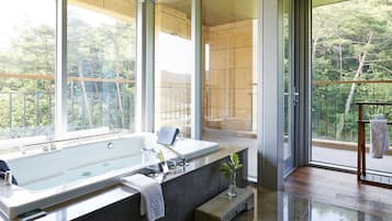 Enjoy a relaxing soak in the bathtub or sit on the bench with a view of the surrounding trees.