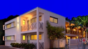A modern two-story building with balconies, large windows, and a gated entrance. - 1818 Meridian House Apartments and Suites by Eskape Collection (Miami Beach)