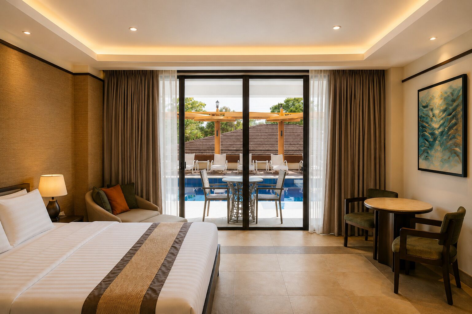 A hotel room with a bed, a desk, a chair, a dining table, and a view of an outdoor pool area.