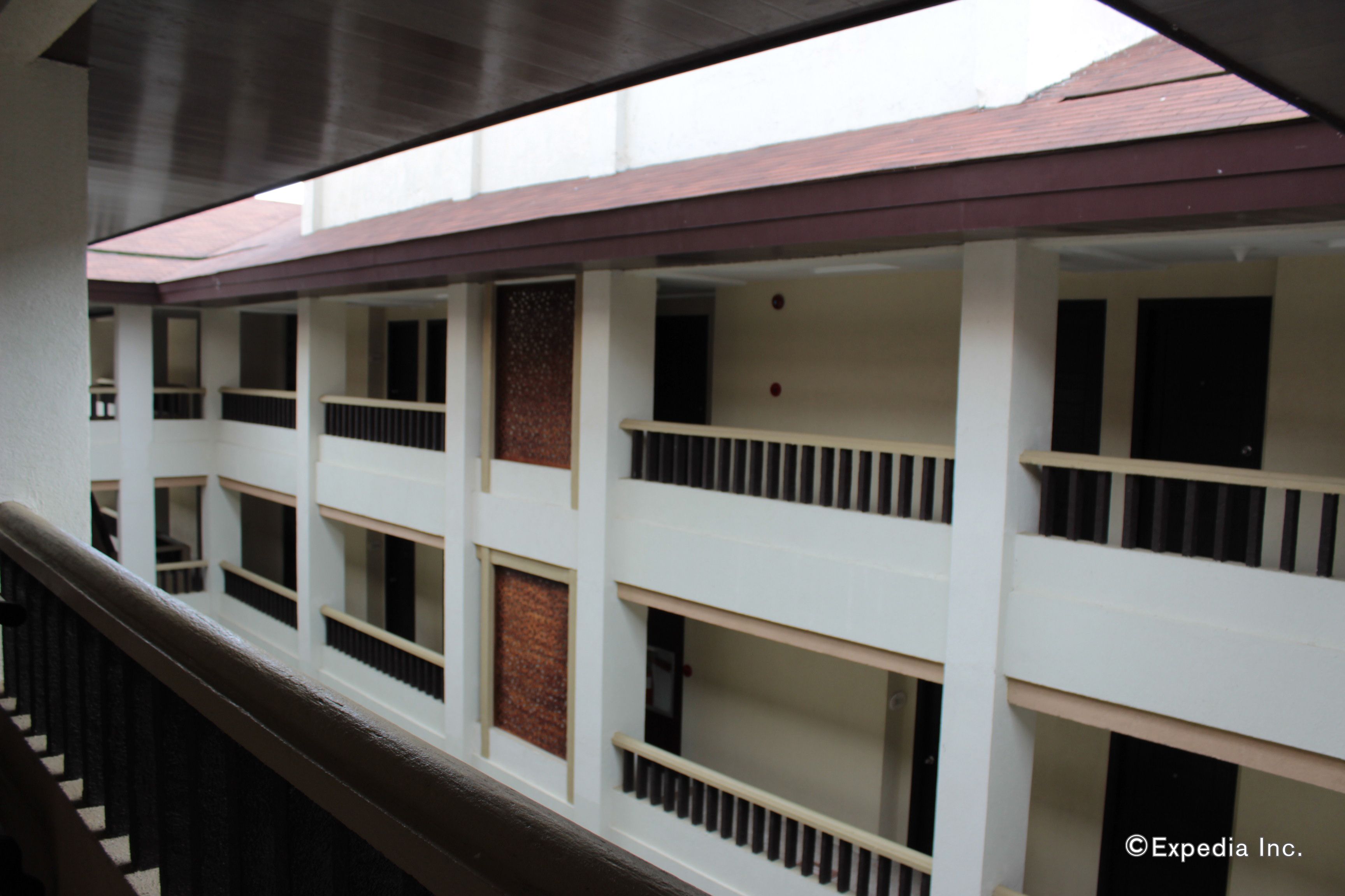 A multi-level building with balconies and a staircase.