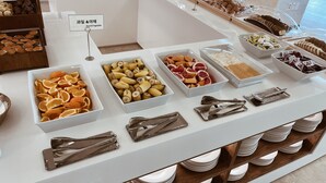 A buffet with various food items including fruits, vegetables, and pastries. - Kumho Jeju Resort (Seogwipo)