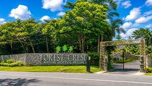 A nature hotel entrance with a stone sign, a gated entrance, and lush greenery. - Forest Crest Nature Hotel and Resort (Nasugbu)