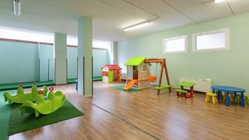 Children can play and explore in this vibrant play area with a slide, swing set, and playhouse.