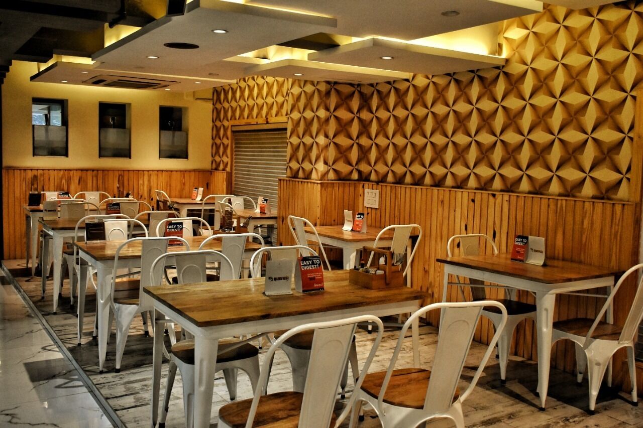 A restaurant with wooden paneling and white chairs. Tables have signs indicating easy-to-digest meals.
