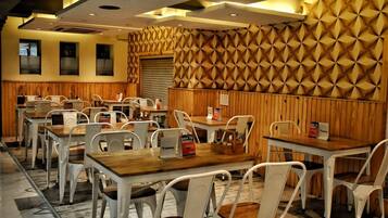 A restaurant with wooden paneling and white chairs. Tables have signs indicating easy-to-digest meals.