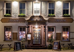 A building with a sign reading "The Manor" above the entrance. - The Manor (St Bees)