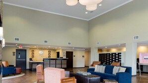 A spacious lobby with a reception desk, seating area, and a wall-mounted information board. - Comfort Suites near Westchase on Beltway 8 (Houston)