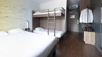 A modern hotel room with bunk beds, a wardrobe, and a coat rack.
