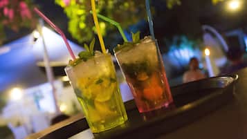 Two drinks with straws on a tray.