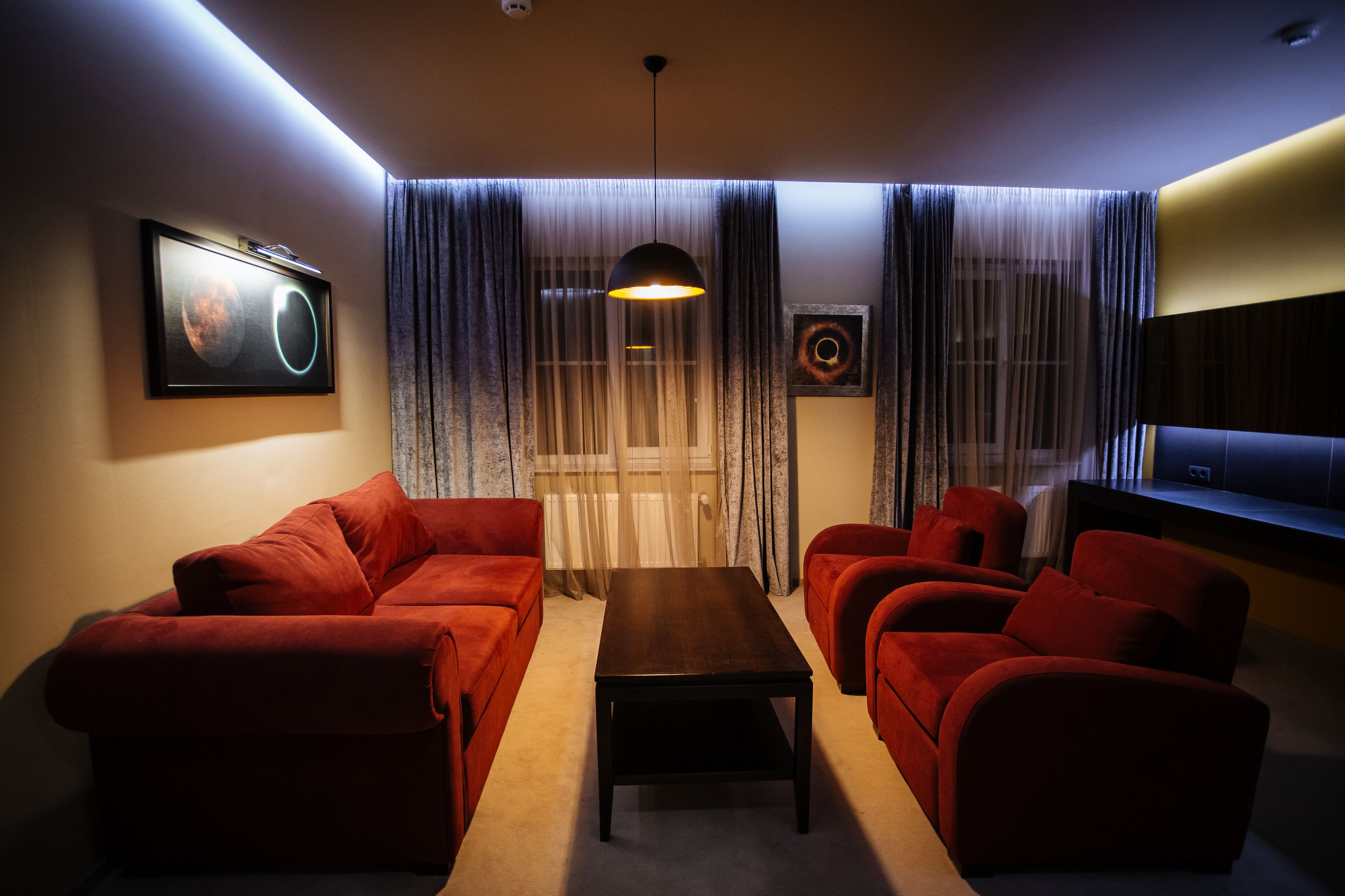 A living room with a sofa set, a coffee table, and a TV.