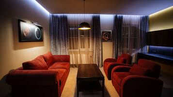 A living room with a sofa set, a coffee table, and a TV.