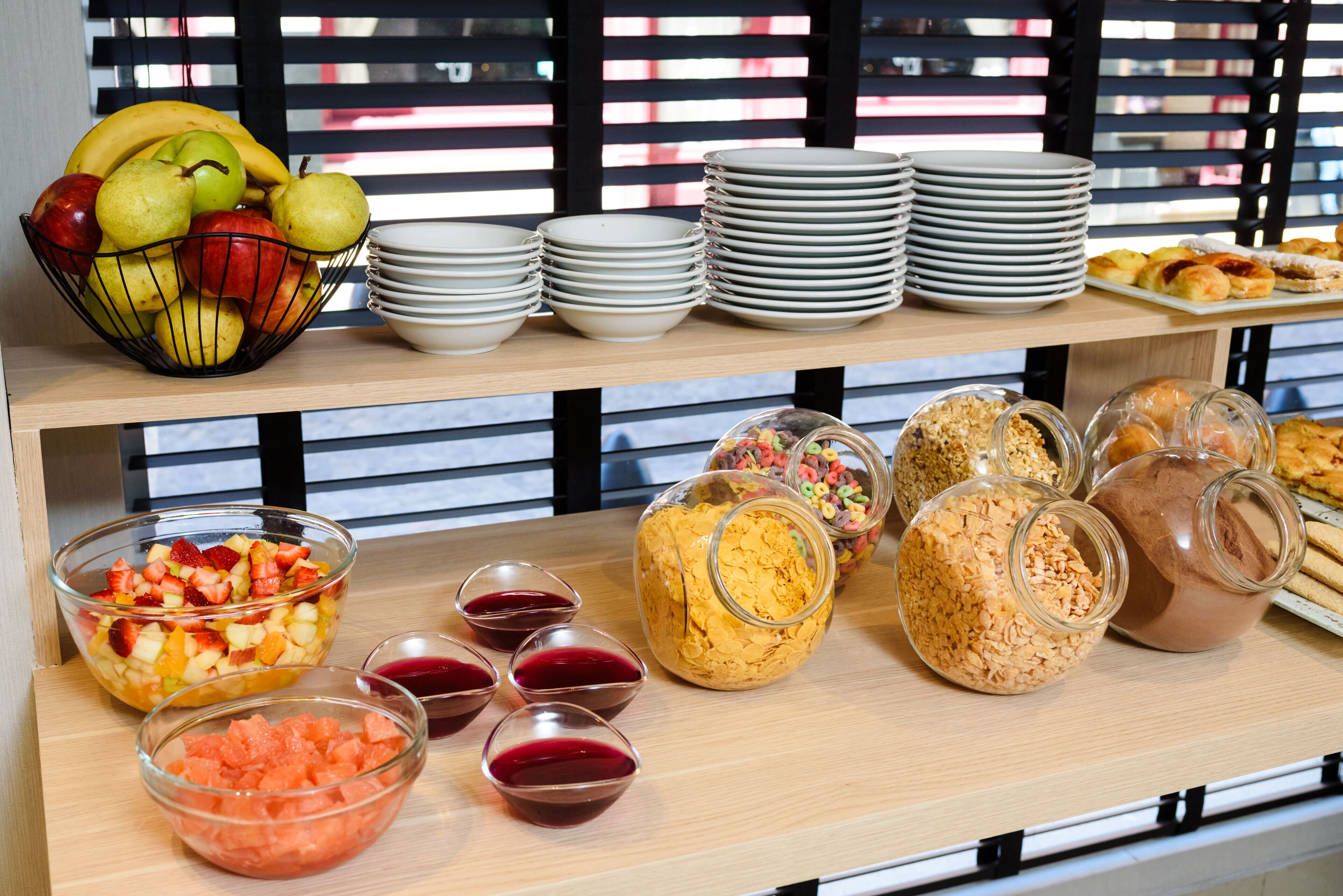 A buffet table with various food items and dishes.