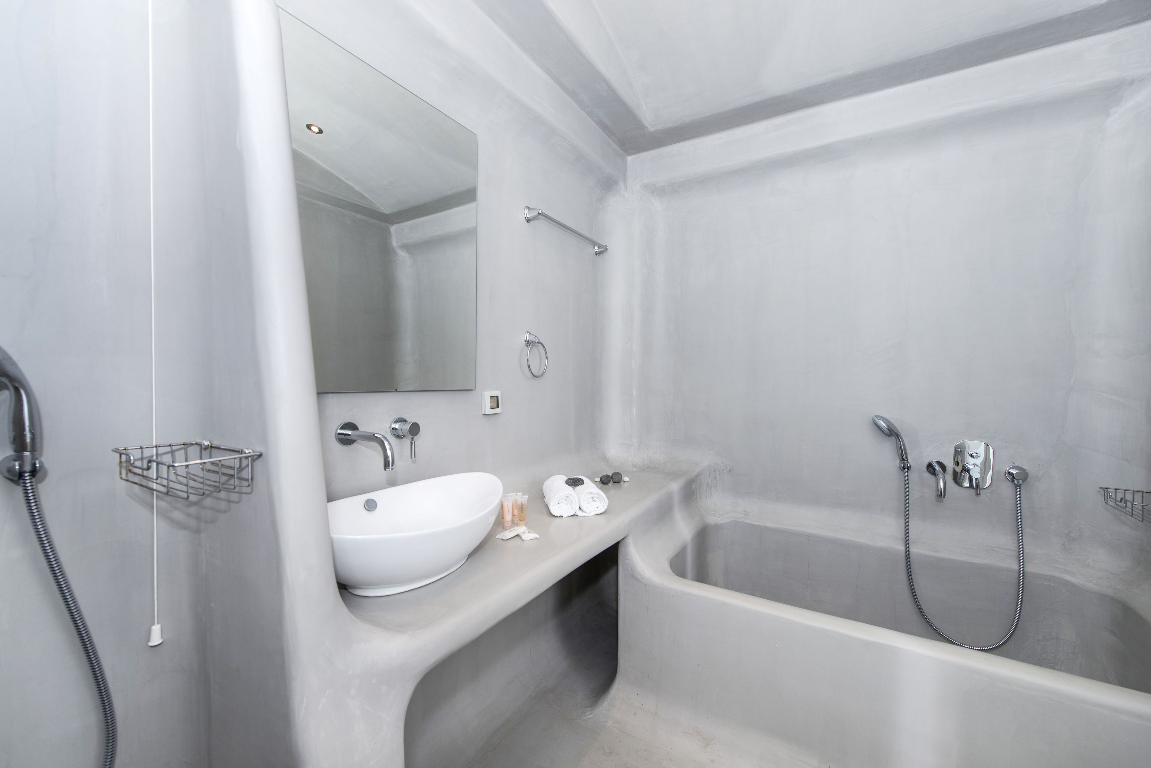 A modern bathroom with a freestanding bathtub, a sink, and a mirror.