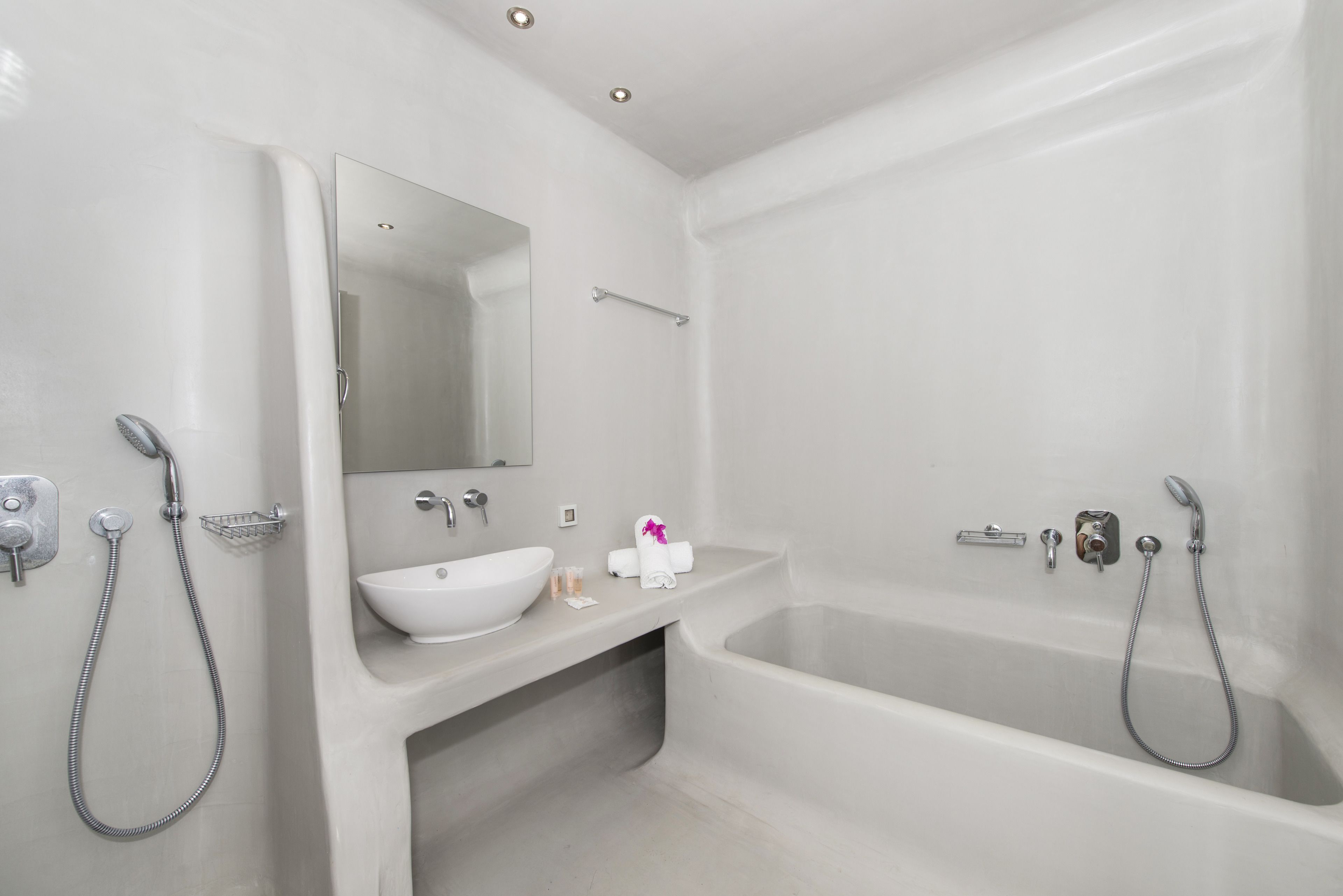 A modern bathroom with a bathtub, a sink, and a mirror.