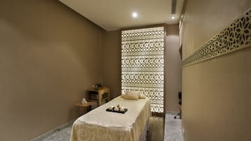 Experience a serene atmosphere in this stylish room with a neatly made bed, bedside table, and decorative wall panel.