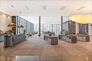 A modern office space with a long reception desk, multiple seating areas, and a large windowed wall. - Quality Hotel Strawberry Arena (Solna)