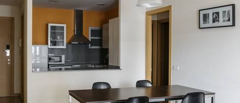 A modern kitchen with a dining area.