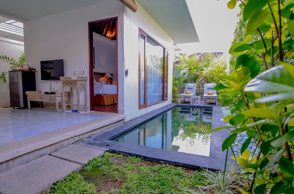 A modern villa with a swimming pool, a bedroom with a large window, and a dining area with a TV.