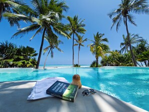 Outdoor pool, an infinity pool, pool loungers