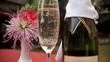 A bottle of Moët & Chandon champagne and a glass on a table with a red tablecloth.