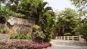 A stone wall with a sign reading "Riverside." - Riverside Serviced Apartments (Ho Chi Minh City)