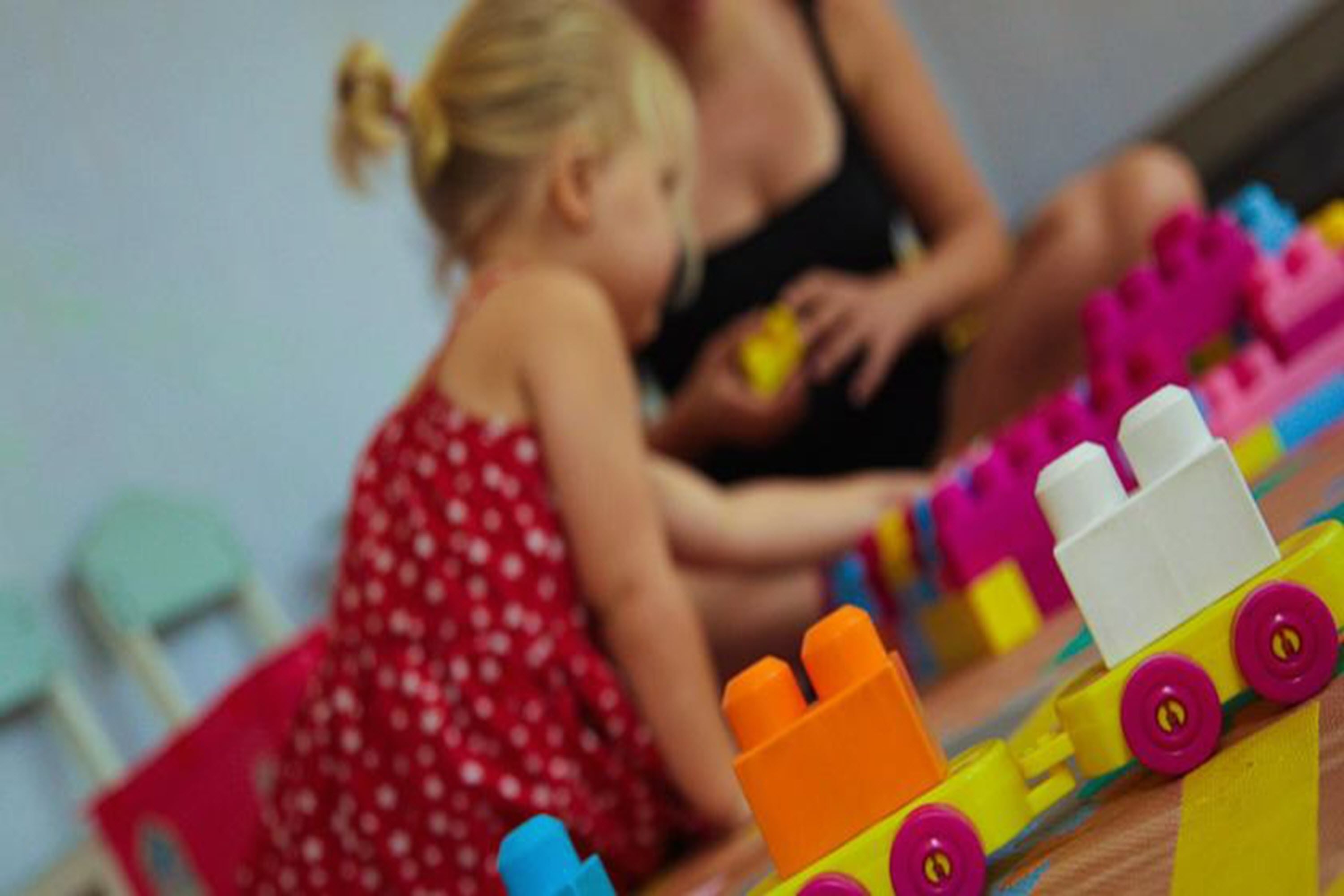 A child playing with colorful building blocks.
