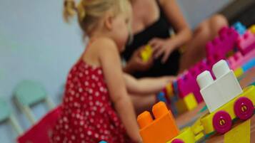 A child playing with colorful building blocks.