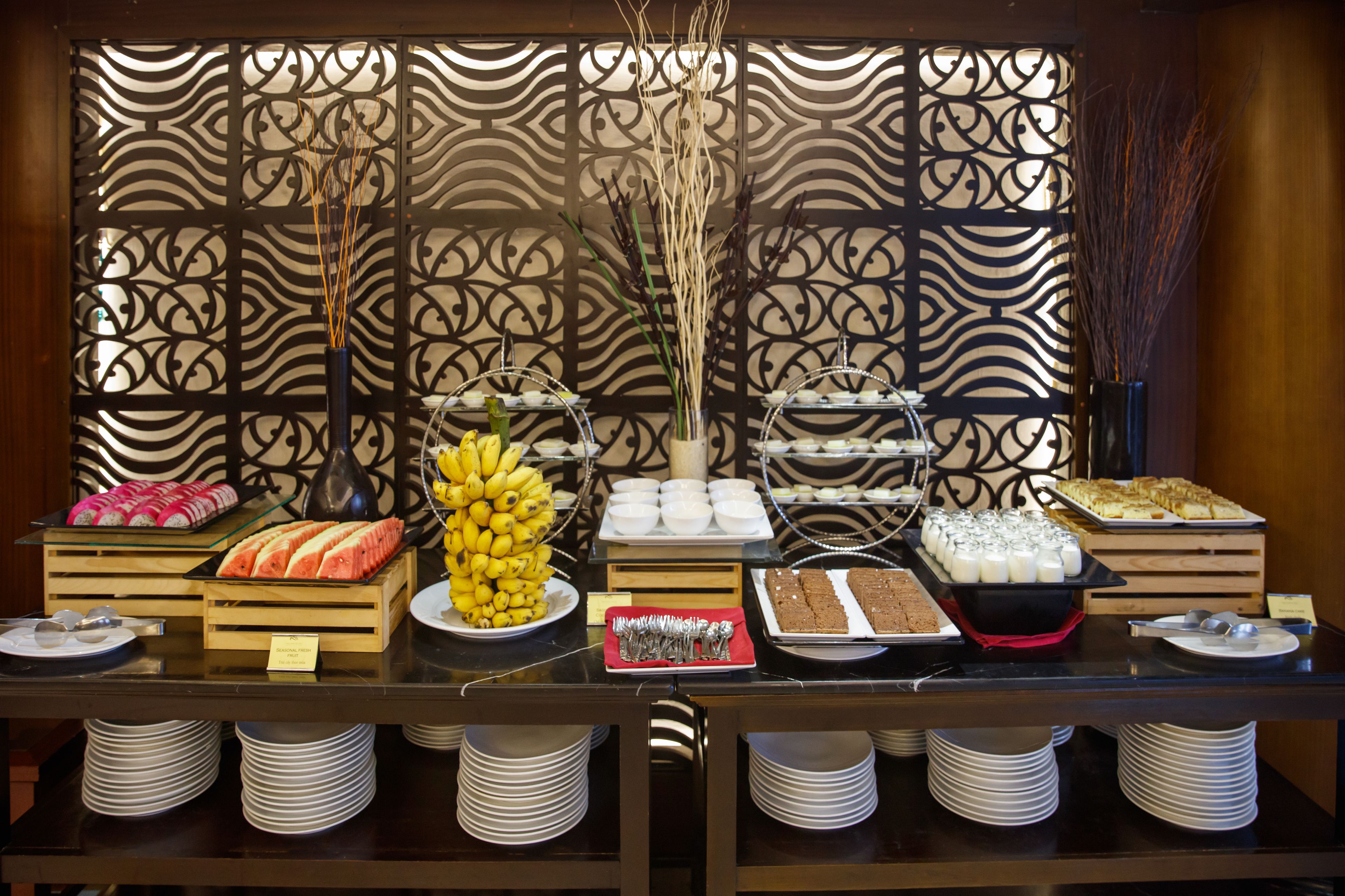 A buffet with various food items and utensils.