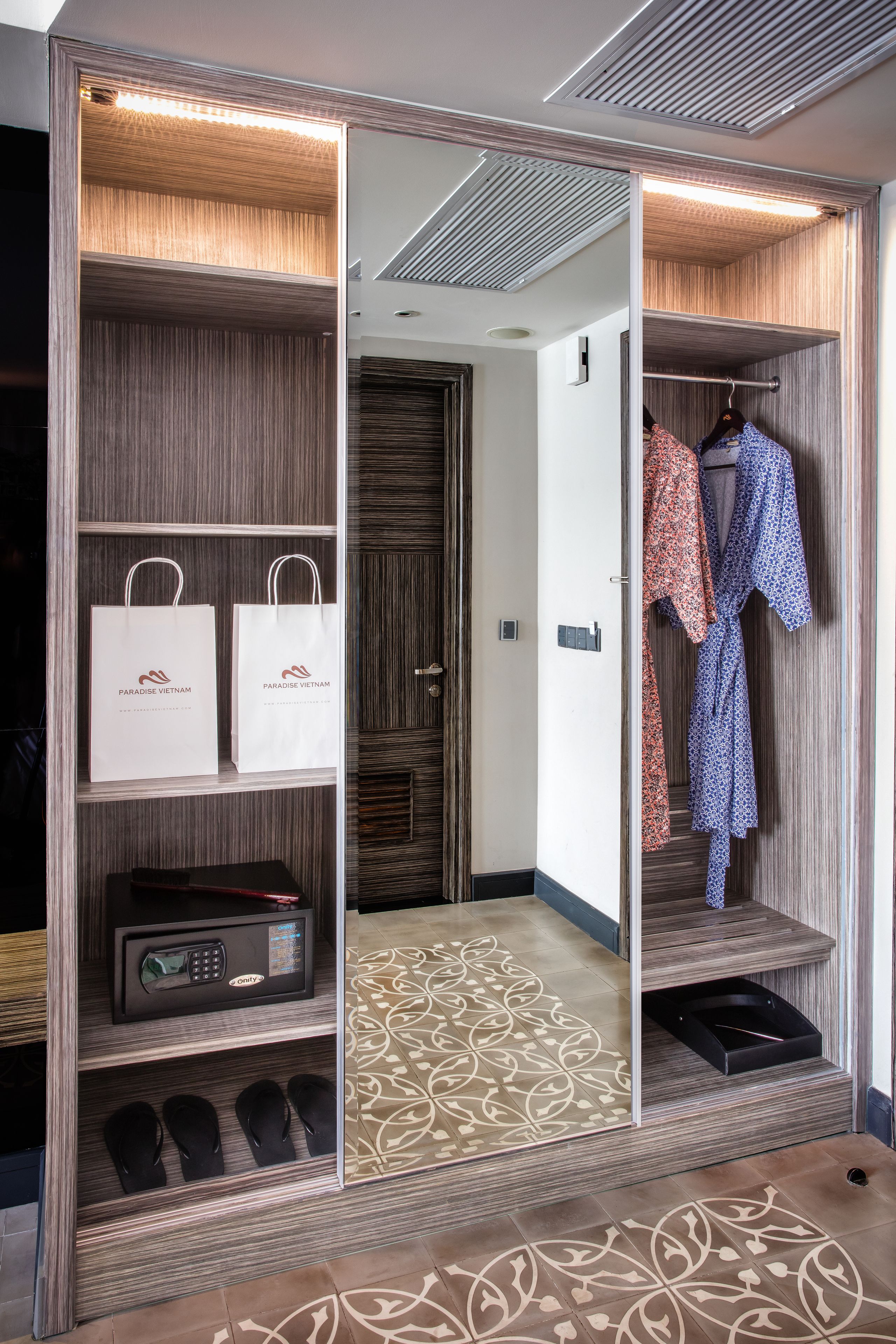 A walk-in closet with storage shelves, a microwave, and a shoe rack.