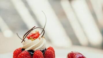 A dessert with raspberries and chocolate on a white plate.