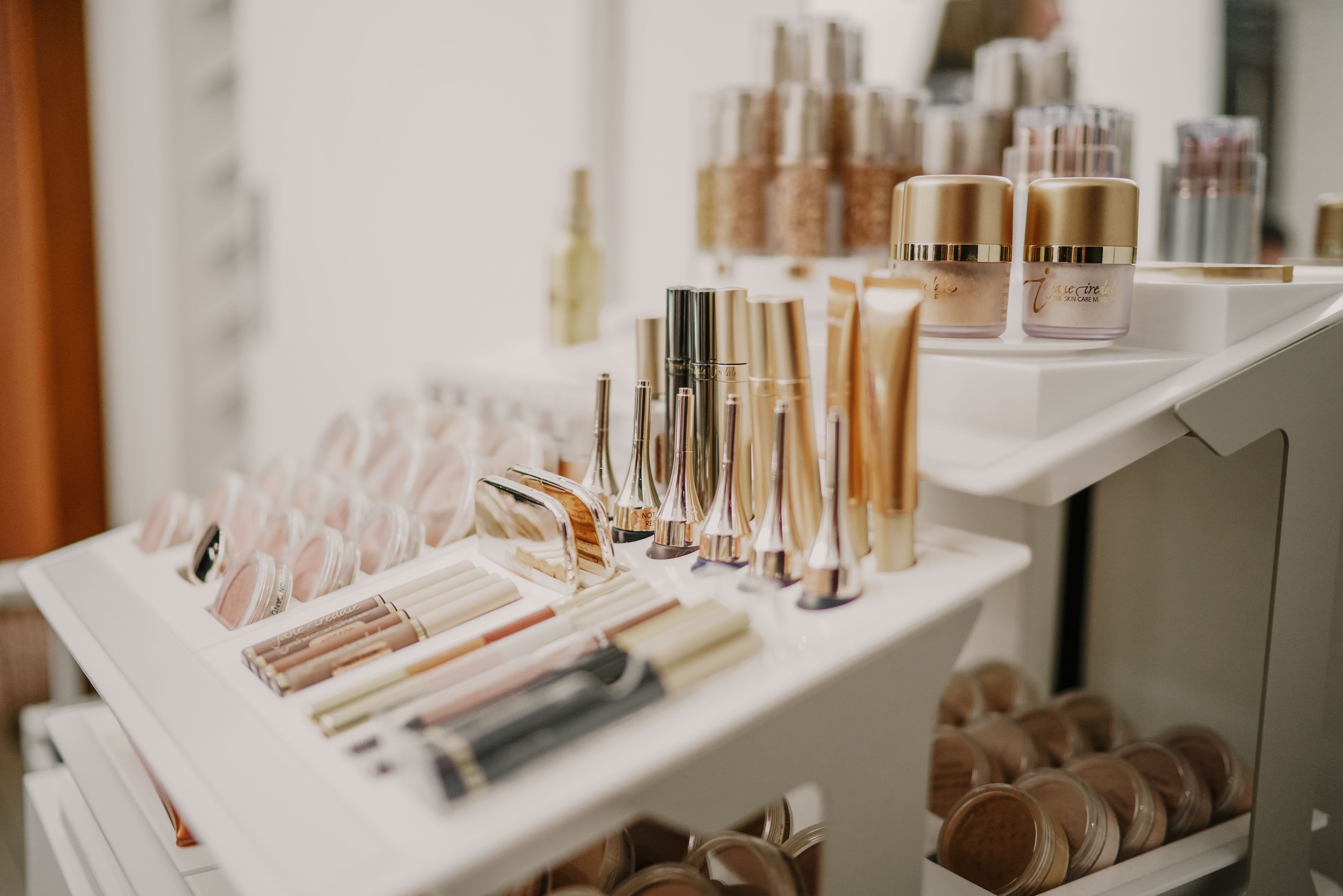 A display of various cosmetic products including lipsticks, creams, and jars.