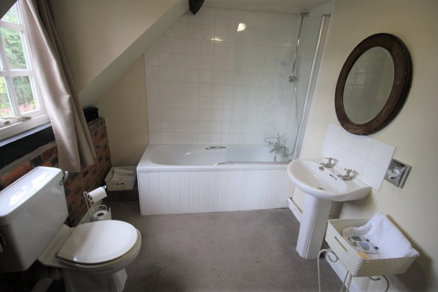 A bathroom with a bathtub, toilet, sink, and a shower.