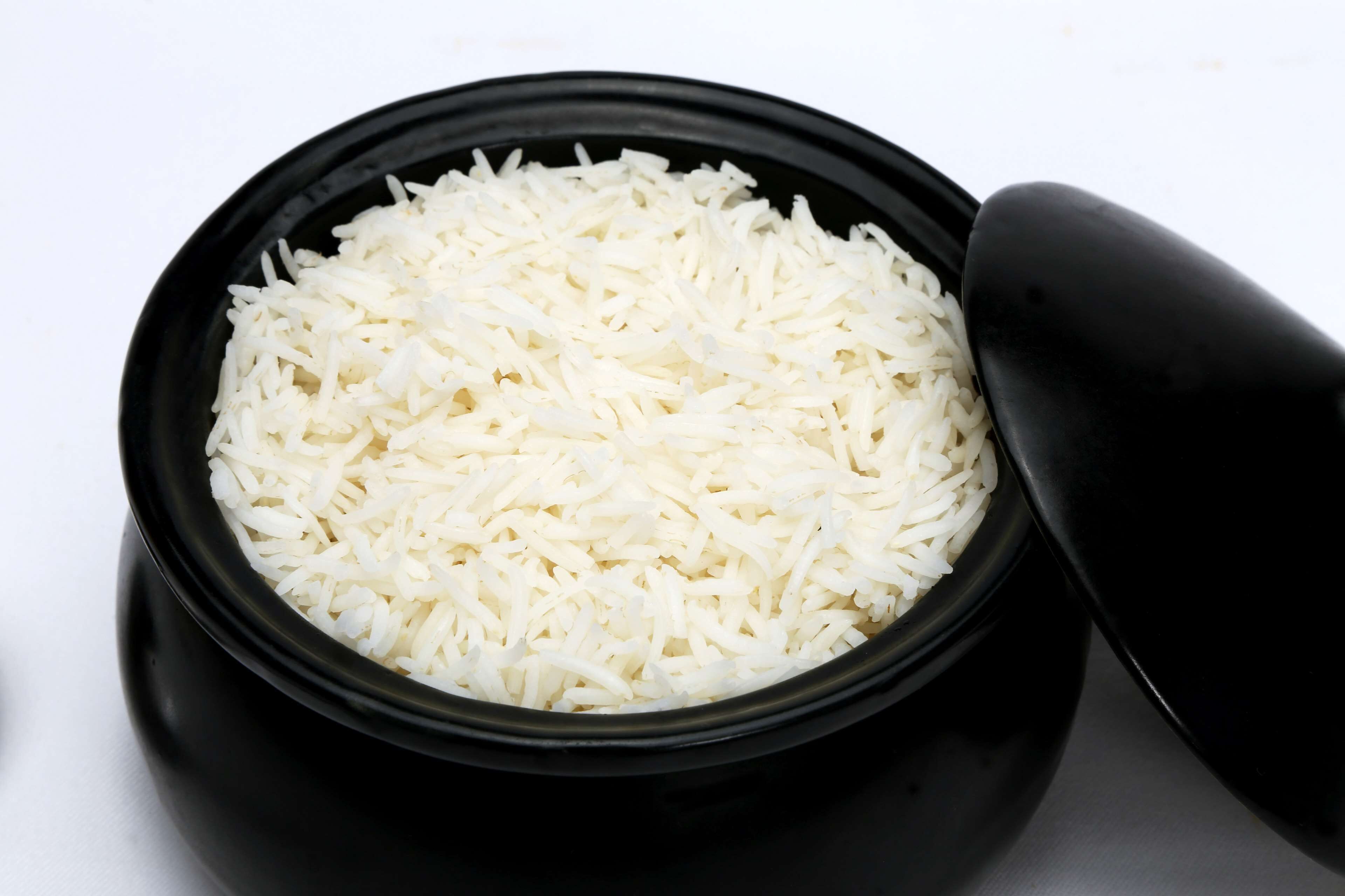 A black bowl filled with white rice.