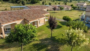 A residential area with multiple houses featuring tiled roofs and a well-maintained lawn. - Résidence du Parc - Gorges de l'Hérault - Cévennes - Parc Sports & Loisirs Brissac Ganges (Brissac)