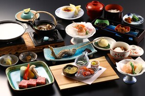 A variety of Japanese dishes arranged on a table, including sushi, sashimi, and other traditional foods. - Shibu Hotel (Yamanouchi)