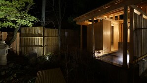A traditional Japanese-style wooden structure with a covered entrance and a small porch area. - Shibu Hotel (Yamanouchi)