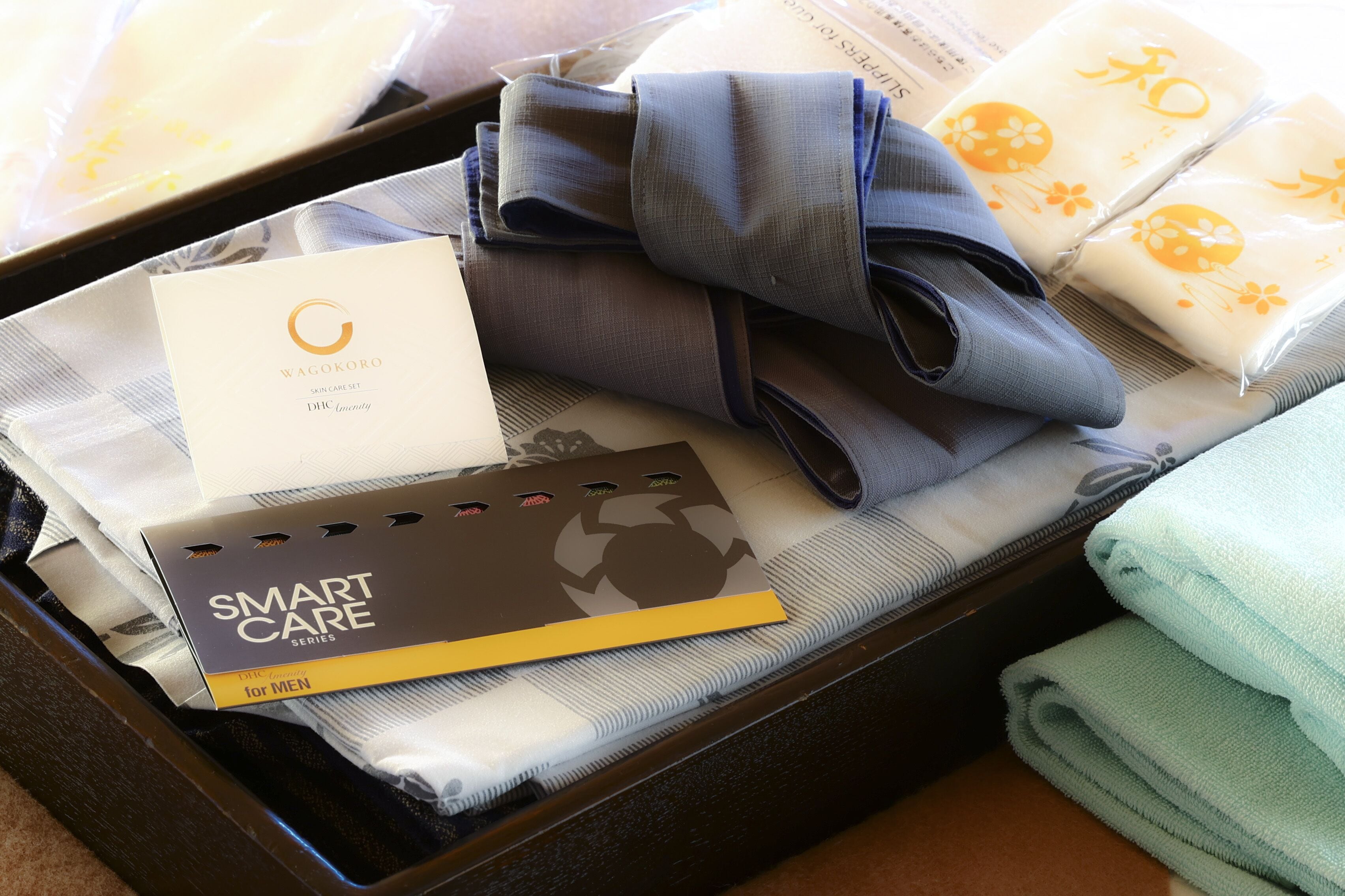 A suitcase containing a skincare set, a smart care card, and folded towels.