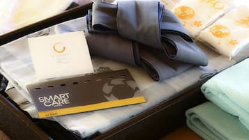 A suitcase containing a skincare set, a smart care card, and folded towels.