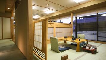 A traditional Japanese room with tatami flooring, a low table, and shoji screens.