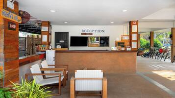 A reception area with a reception desk, seating area, and a view of the outside.