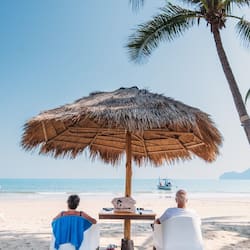 On the beach, white sand, sun-loungers, beach umbrellas