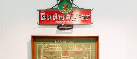 A foosball table with a framed map of Las Vegas and a sign above it.