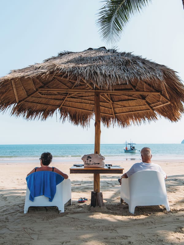 On the beach, white sand, sun-loungers, beach umbrellas
