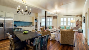 A spacious kitchen with a dining area, a living room with a fireplace, and a cozy seating arrangement. - Hotel Florence, Tapestry Collection by Hilton (Florence)