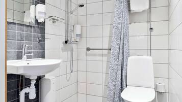 A modern bathroom with a white sink, toilet, and shower.